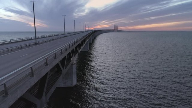 Empty &Oslash;resund Bridge, Malm&ouml;, Sweden aerial drone view. Quarantined city Copenhagen, Denmark. Empty abandoned bridge, streets and roads during corona virus outbreak