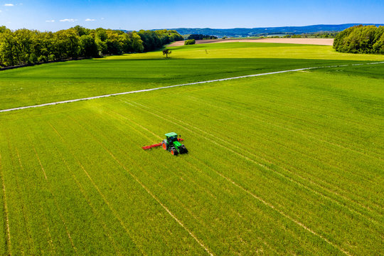 Aerial view of tractor on field, soil loosening, Hochtaunuskreis, Hesse, Germany