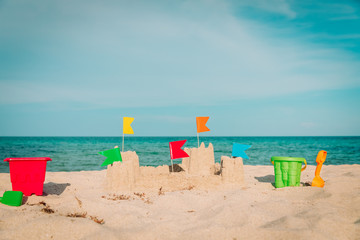 Sand castle on beach vacation and toys