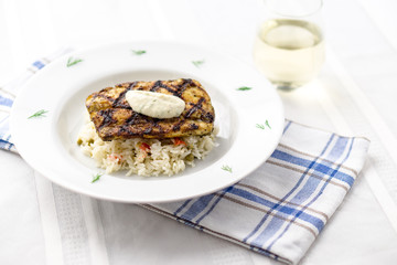 Mahi mahi grilled fish with rice and wine. This lean tropical white fish is also known as common dolphinfish or dorado. Considered an healthy food rich in protein, it is perfect for bbq grilling.