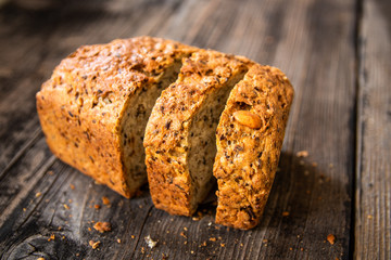 Homemade healthy freshly baked organic whole grain bread with healthy seeds on wooden table