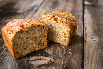 Homemade healthy freshly baked organic whole grain bread with healthy seeds on wooden table
