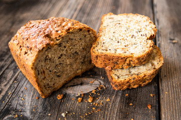 Homemade healthy freshly baked organic whole grain bread with healthy seeds on wooden table