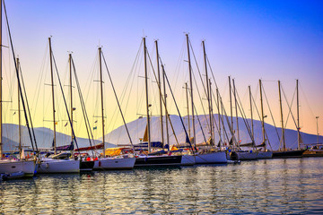 Sailboats in the port at sunset
