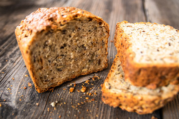 Homemade healthy freshly baked organic whole grain bread with healthy seeds on wooden table