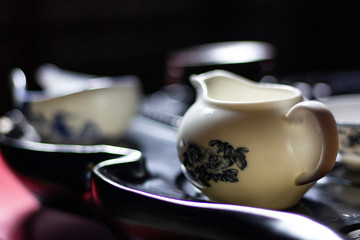 White china with blue gzhel for tea ceremony on wooden black tea table