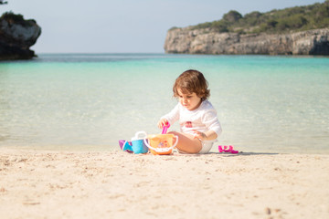  baby playing on the beach, Menorca Cala Turqueta