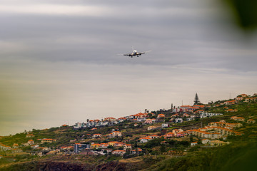 Fototapeta premium Plane approaching landing on Madeira airport, Portugal