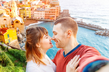 Vernazza, national park Cinque Terre, Liguria, Italy, Europe. Tourists happy couple taking selfie...