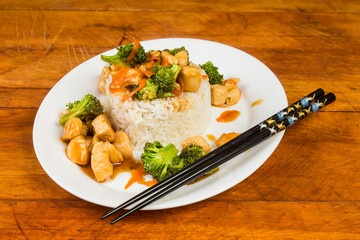 Chicken and Broccoli Stir Fry on Bed of Sticky Rice with Chopsticks