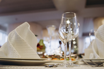 Wine glasses and glasses on the server table.Luxurious elegant dinner at the table in the restaurant. Holiday table decoration