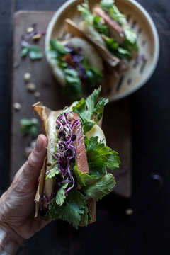 Close Up Of Woman Holding Gua Bao Sandwich With Bacon