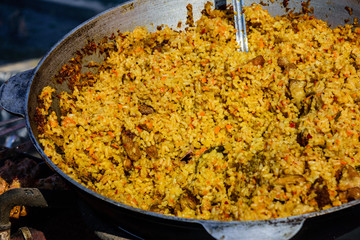 Big pan with pilaf on street festival