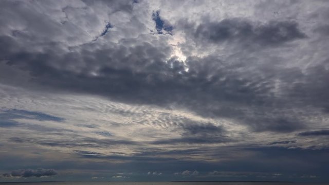 time lapse of clouds over the sea during sunset