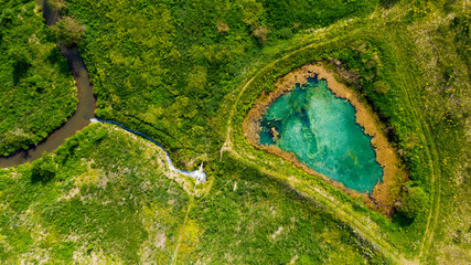 Aerial view from the drone of summer landscape with river, hills and forests.