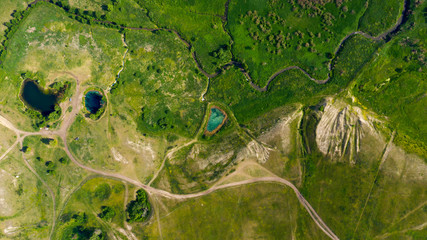  Aerial view from the drone of summer landscape with river, hills and forests.