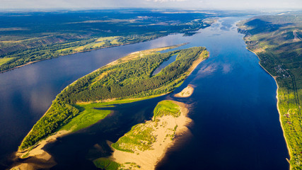  Aerial view from the drone of landscape Volga river flows among the hills and fields. The middle band of Russia.