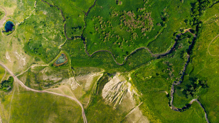  Aerial view from the drone of summer landscape with river, hills and forests.