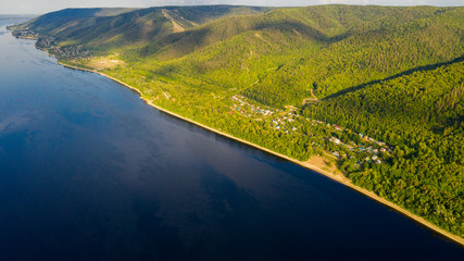  Aerial view from the drone of landscape Volga river flows among the hills and fields. The middle band of Russia.