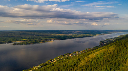  Aerial view from the drone of landscape Volga river flows among the hills and fields. The middle band of Russia.