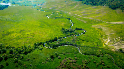  Aerial view from the drone of summer landscape with river, hills and forests.