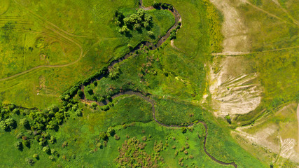  Aerial view from the drone of summer landscape with river, hills and forests.