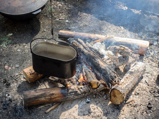 Bonfire and pot hanging over the it.