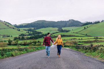 Fototapeta premium the couple in love walking along the road overlooking the mounta