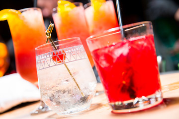 a group of cocktails on a wooden rack