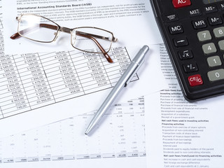 Calculator points and pen on financial documents