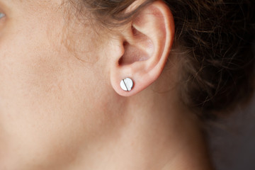 girl with a piercing in the ear, ear tunnels close-up lifestyle