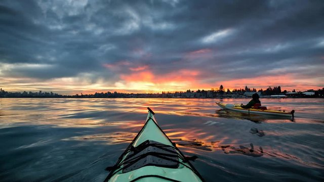Sea kayaking during a dramatic cloudy sunrise near Downtown Vancouver, British Columbia, Canada. Still Image Continuous Animation