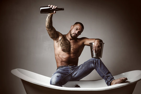 Celebrate Purchase Real Estate. Celebrate Luxury Life. Celebrate Achievement. Champagne Celebration In Luxury Bathtub. Handsome Attractive Man Tattooed Body Drinking Expensive Champagne. Night Party