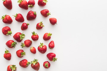 top view of sweet and red strawberries on white background with copy space