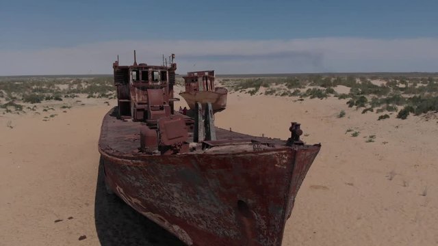 Real model of former sea boat on a pedestal as monument of passed days when Mo'ynoq was an active sea port on Aral sea. Picture taken in former piscatorial port Mo'ynoq Moynaq or Muynak, Uzbekistan.