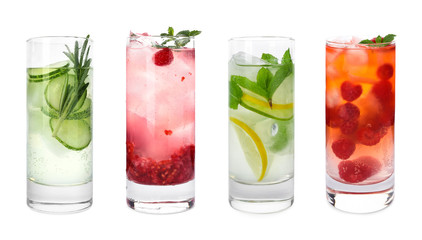 Set of glasses with different refreshing drinks on white background