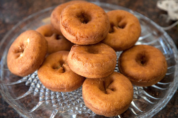 Fototapeta na wymiar A stack of plain donuts on a glass plate. St Paul Minnesota MN USA
