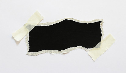 Ripped paper black background, space for advertising copy.