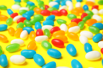Delicious jelly beans on color background, closeup