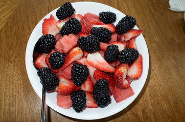 Serving bowel of black and red fruit strawberries and blackberries. St Paul Minnesota MN USA