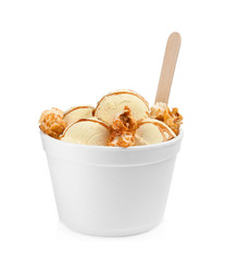 Delicious ice cream with caramel popcorn and sauce in dessert bowl on white background