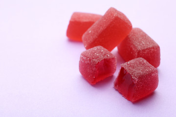 Tasty jelly candies on color background, space for text