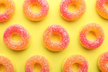 Tasty jelly candies on color background, flat lay