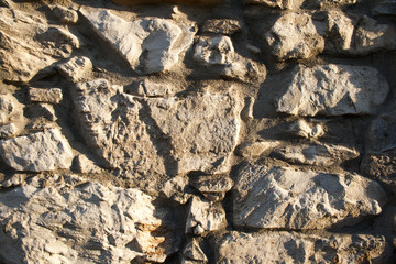 Background, material, texture of a natural stone facade