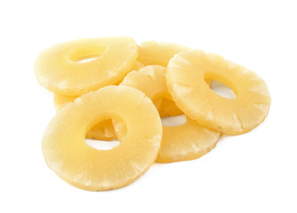 Slices of delicious sweet canned pineapple on white background