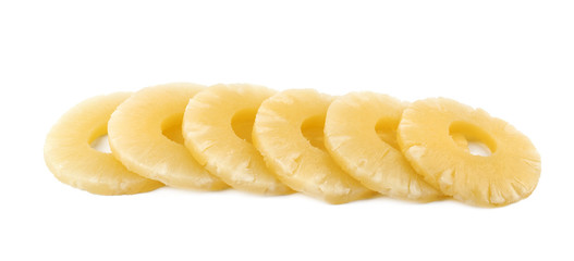 Slices of delicious sweet canned pineapple on white background