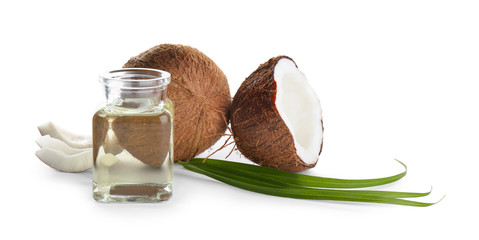 Ripe coconuts and jar with natural organic oil on white background