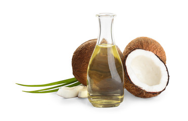 Ripe coconuts and bottle with natural organic oil on white background