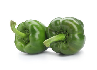 Ripe green bell peppers on white background