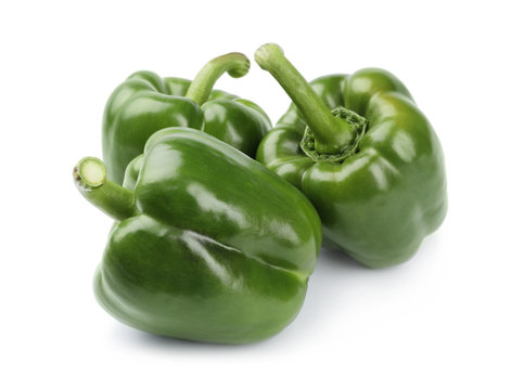 Ripe green bell peppers on white background